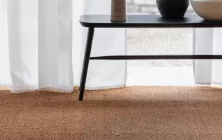 room with coffee table stood on natural coir herring bone carpet